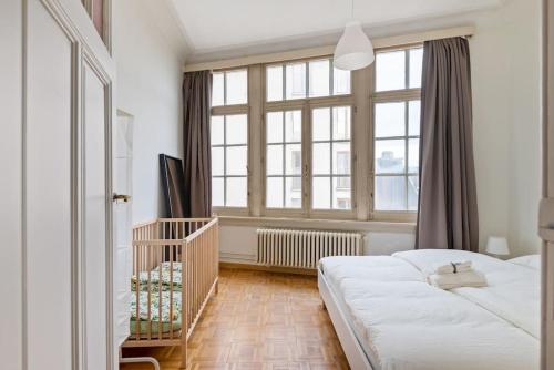 a bedroom with a bed and a large window at The Workspace w/Free Parking in Antwerp