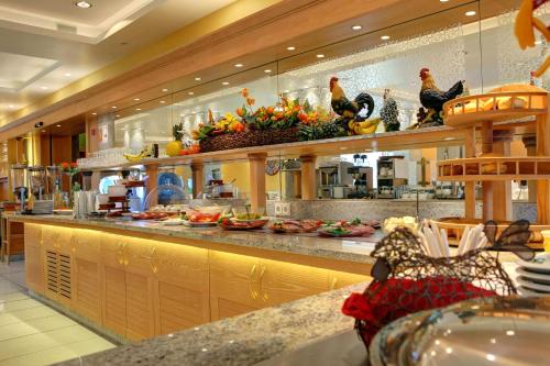 a kitchen with a counter with food on it at Hotel Mühlenthal GmbH in Schwalbach