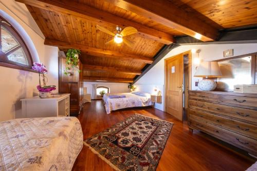 a bedroom with two beds and a wooden ceiling at Casa Giovannella in Feltre