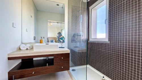 a bathroom with a sink and a shower at Villa Blue Marlin by LovelyStay in Calheta