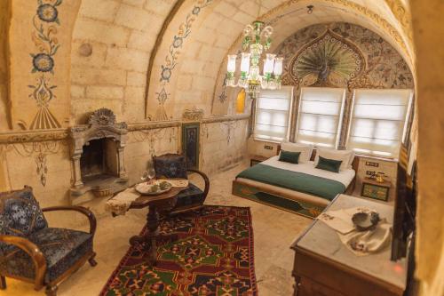 a bedroom with a bed and a fireplace at Solo Cave Suites in Nevsehir
