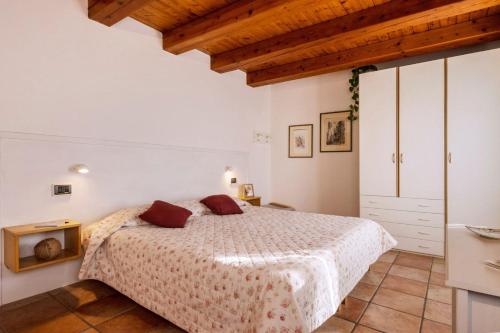 a bedroom with a bed and a wooden ceiling at Casa Giovannella in Feltre