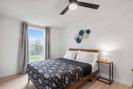 a bedroom with a bed and a ceiling fan at Starlight Horizon Cabin C - Pet-Friendly Texas Hill Country Cabin Near Canyon Lake - Pool, Stargazing & Group Getaways Sleeps 8 in Canyon Lake