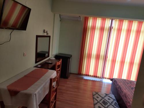 a bedroom with a bed and a dresser and a mirror at Motel Elegance in Sandanski