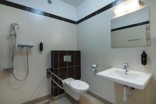 a bathroom with a toilet and a sink and a shower at MariSol in Świnoujście
