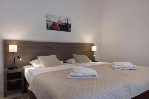 two beds in a hotel room with towels on them at MariSol in Świnoujście