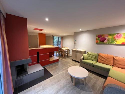 sala de estar con sofá y cocina en Cottage 6p-les hauts de bruyères-765, en Chaumont-sur-Tharonne