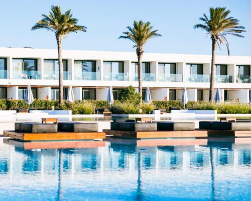 an exterior view of a building with palm trees at Gennadi Grand Resort in Gennadi