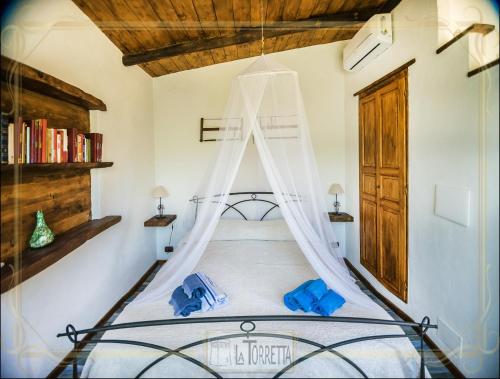 a bedroom with a bed with a canopy at B&B La Torretta in Maratea