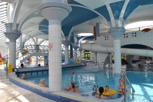 a group of people in a swimming pool on a cruise ship at Termálfalu és Kemping Zalaegerszeg - Standard Plus in Zalaegerszeg