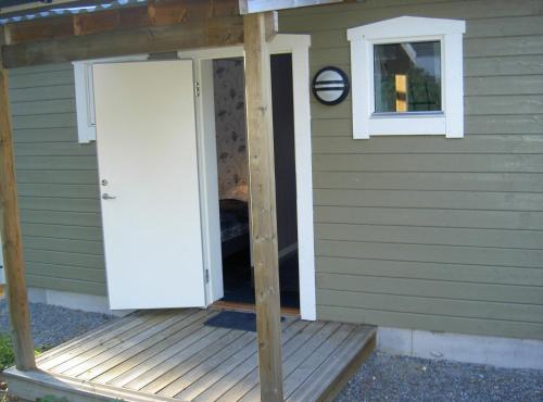 a porch of a house with a door and a window at Elvis Stuga in Östersund