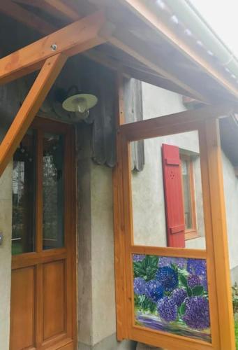 a pair of doors on a house with a window at Gîte de la Mésange in Rochesson