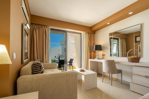 a living room with a couch and a table at Kamari Beach in Lardos