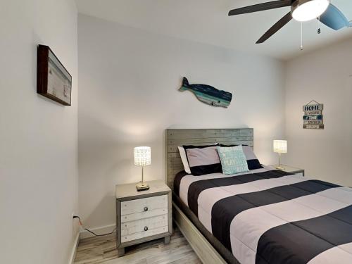 a bedroom with two beds and a ceiling fan at Oasis On The Bay in Rockport