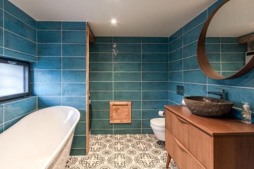 a bathroom with a tub and a toilet and a sink at Chalet ZigueZague - Calme - Proche Thermes in Saint-Gervais-les-Bains