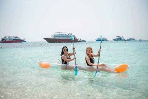 two women are sitting in a kayak in the water at Hurghada in Hurghada