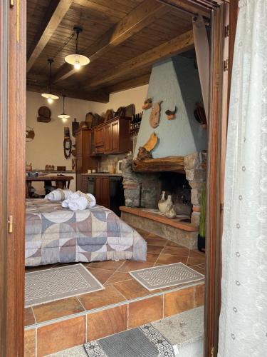 a bedroom with a bed and a stone fireplace at B&B La Baita "monolocale ad uso esclusivo" in Fonni