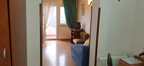 a hallway with a room with a window and a television at Apartments and Rooms Laura in Pazin