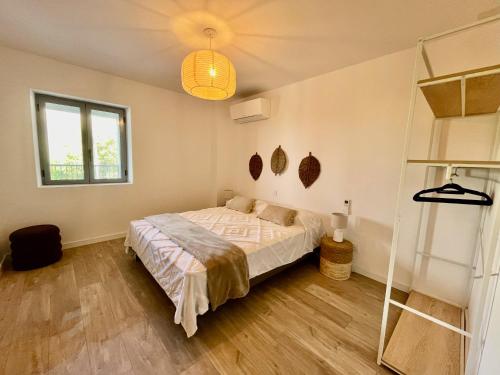 a bedroom with a bed and a window at Hôtel Résidence CAPENSE in Centuri