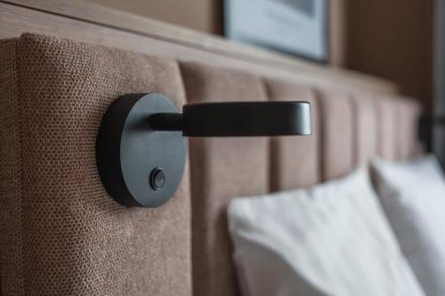 a close up of a black handle on a wall at Sky Hotel Apartments, Stockholm in Stockholm
