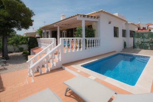 a villa with a swimming pool and a house at Casa Novo Horizonte by Portucasa in Altura