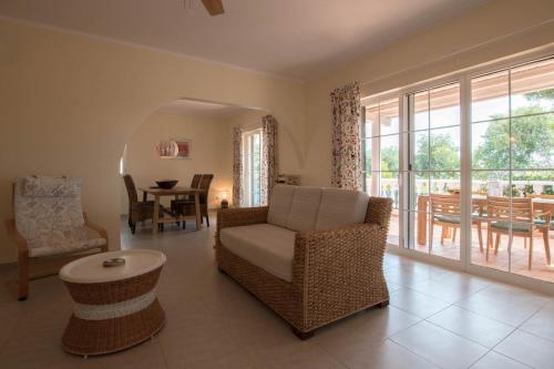 a living room with a chair and a table at Casa Novo Horizonte by Portucasa in Altura