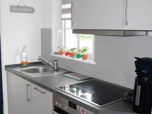 une cuisine avec un évier et un plan de travail dans l'établissement Maison neuve avec jardin proche centre et plage, 2 chambres, terrasse et parking - FR-1-418-220, au Palais