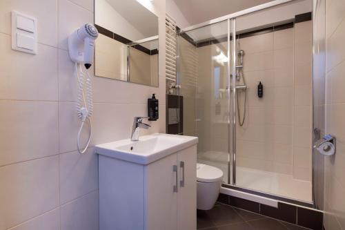 a bathroom with a sink and a shower and a toilet at MariSol in Świnoujście