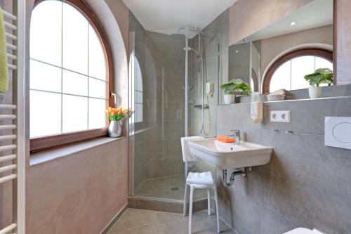 a bathroom with a sink and a shower at Hotel Restaurant Falken in Baiersbronn