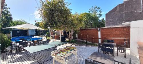 a patio with a table and chairs and a pool at Hotel Namaste in Mendoza