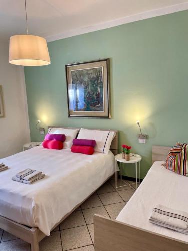 a bedroom with two beds with red pillows at Bnbook Lago Maggiore Studio 2 in Dormelletto