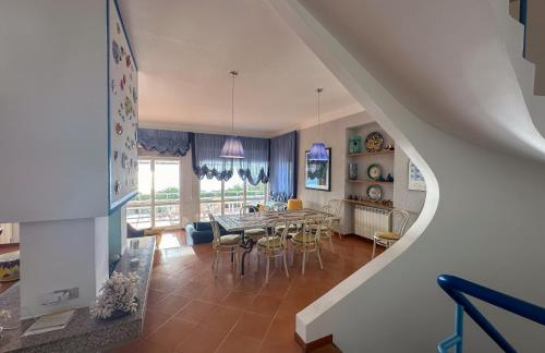 a kitchen and dining room with a table and chairs at Villa Le Cale in Monte Argentario
