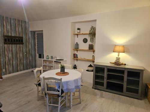 a living room with a table and chairs and a table and a lamp at Balade sur le port in Dinan