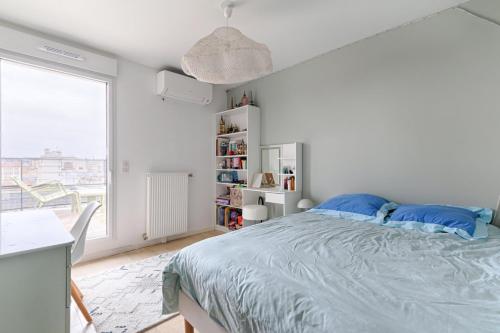 a white bedroom with a bed and a window at Resident- Beautiful 6P apartment in Montrouge