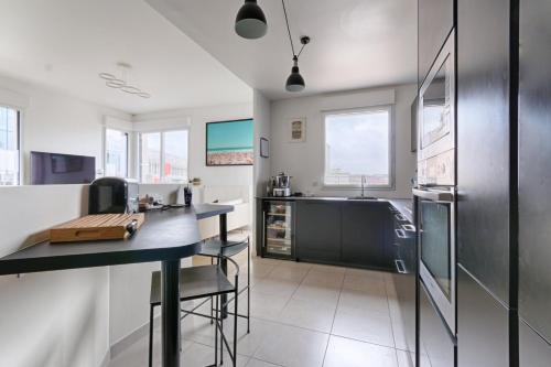 a kitchen with a counter and a refrigerator at Resident- Beautiful 6P apartment in Montrouge