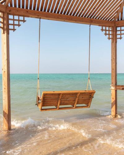 a swing on the beach near the ocean at orange bay in Hurghada