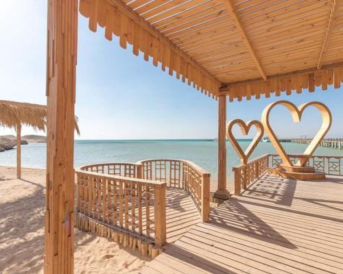 a wooden deck with two heart signs on the beach at orange bay in Hurghada