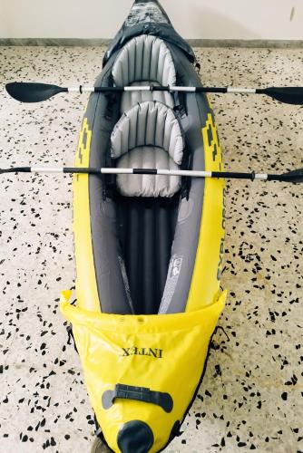 a yellow and black kayak sitting on the beach at Le volte di Umberto: camera e rilassante terrazzo in Sogliano Cavour