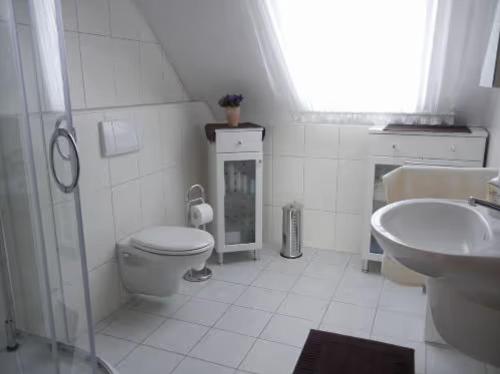 uma casa de banho branca com um WC e um lavatório em Ferienwohnung 1 Schulze em Neustrelitz