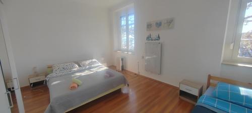 a small bedroom with a bed and a couch at Leon in Rijeka