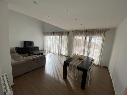 a living room with a couch and a table at Casa Rural El Pino in Albacete