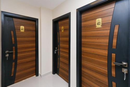 a row of wooden doors in a hallway at Diamond Pyramids View Inn in Cairo