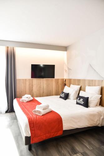 a bedroom with a large bed with towels on it at Hotel Mercure Château de Fontainebleau in Fontainebleau