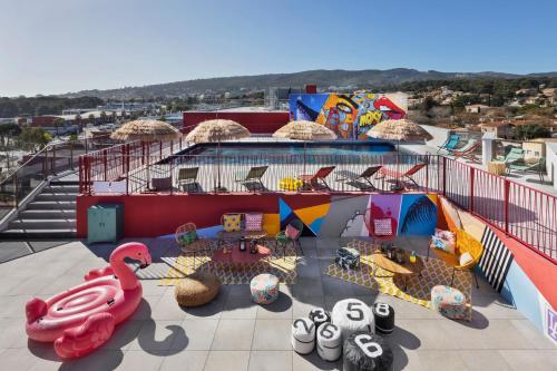 an indoor playground with a pool and a fake swan at Moxy La Ciotat in La Ciotat