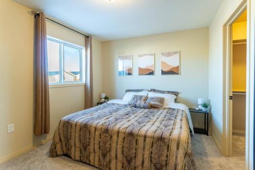 a bedroom with a large bed and a window at Cozy Countryside Crib in Grande Prairie