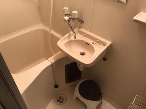 a bathroom with a sink next to a bath tub at Vintage III - Vacation STAY 14907 in Fukuoka