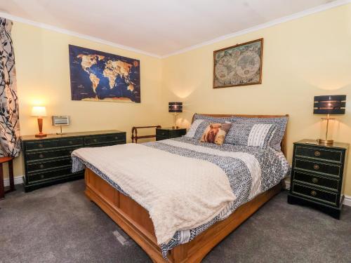 a bedroom with a bed with a dog laying on it at Millers Cottage in Malton