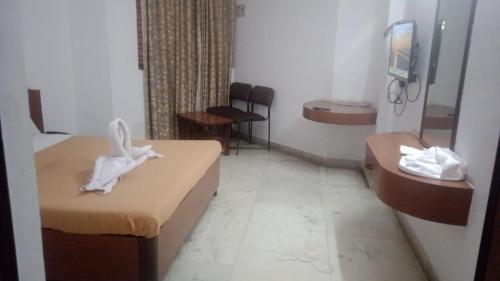 Krevet ili kreveti u jedinici u okviru objekta Kadambakrishna residency