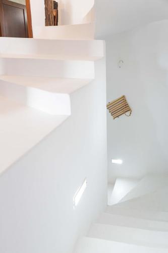 a staircase in a house with white walls at Maria's Traditional Villa in Asklipiḯon