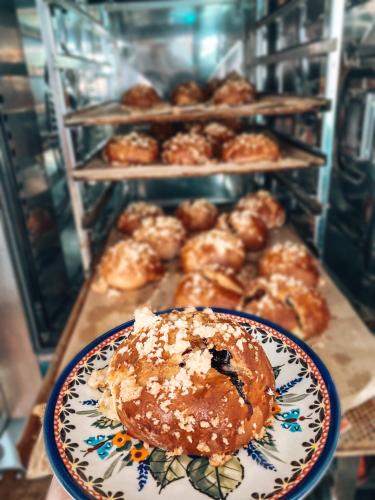 a table with a plate of donuts and other pastries at Dom Malowany in Wetlina